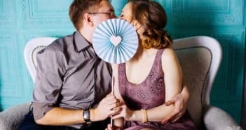 Woman and Man Sitting on Grey Suede Loveseat