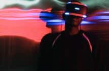 Man in VR Glasses in Illuminated Room