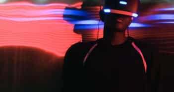 Man in VR Glasses in Illuminated Room