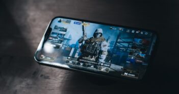 a person holding a cell phone with a video game on the screen