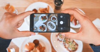 person taking picture of the foods