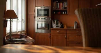 silver microwave oven on brown wooden cabinet