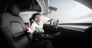 a man sitting in a car with headphones on