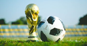 gold-colored trophy and soccerball