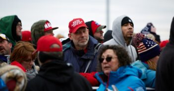 group of people in red cap and blue jacket