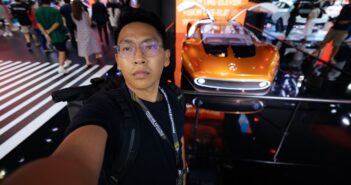 A man standing in front of a display of cars