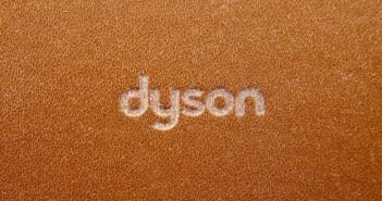 the word dyson written on a brown leather surface