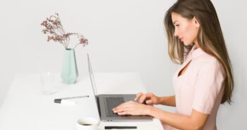 Woman in Pink Dress Using Laptop Computer