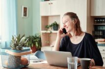 Woman Talking on Phone at Dining Table