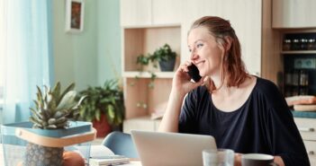 Woman Talking on Phone at Dining Table