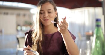 Woman in Purple Eating