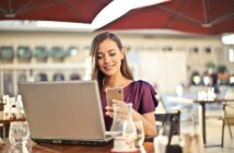 Woman Wearing Purple Shirt Holding Smartphone White Sitting on Chair