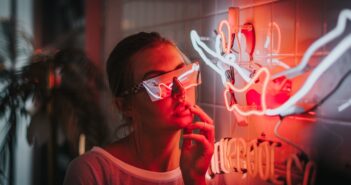 woman standing beside lighted neon lights