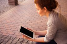 woman holding white iPad