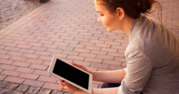 woman holding white iPad