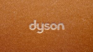 the word dyson written on a brown leather surface