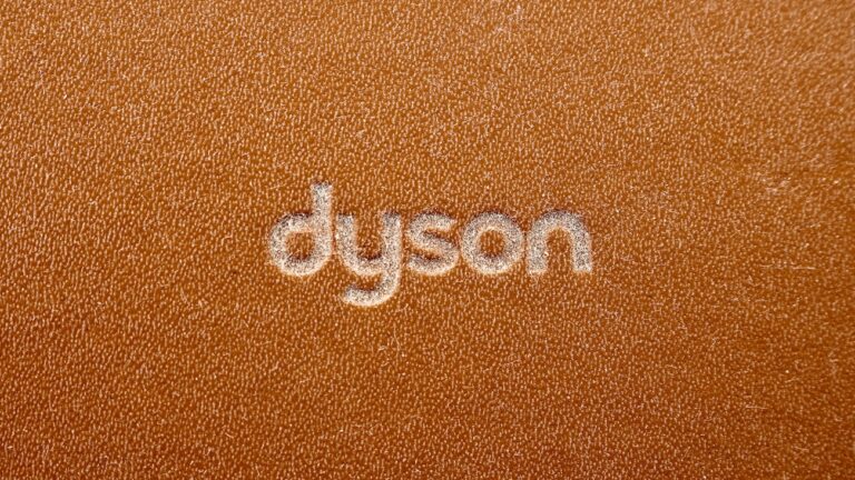 the word dyson written on a brown leather surface