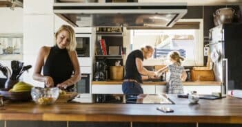 Parents preparing food with daughter (2-3) in kitchen