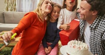 Smiling family having birthday party with cake