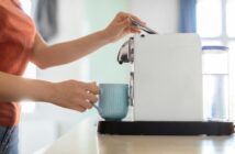 Unrecognizable Woman Preparing Morning Coffee With Modern Machine In Kitchen