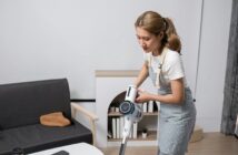 Young Woman Cleaning Modern Living Room with Vacuum Cleaner, Housekeeping and Home Maintenance