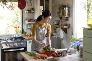 Asian woman busy cooking in the kitchen