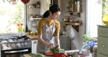 Asian woman busy cooking in the kitchen