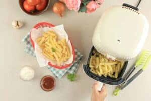 Female Hand Take Out Airfryer Tray Machine Ccooking.