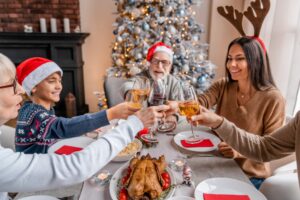 Happy family toasting with wine on Christmas eve