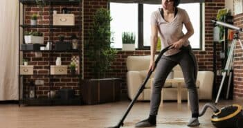 Modern woman using vacuum cleaner