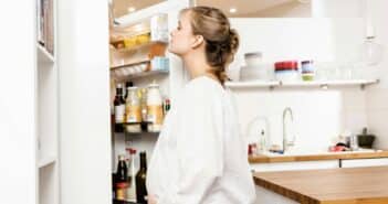 Pregnant woman searching fridge for food