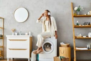 Spinning suds: woman on washing machine