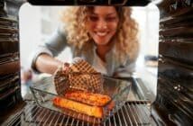 View Looking Out From Inside Oven As Woman Cooks Oven Baked Salmon