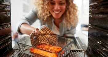 View Looking Out From Inside Oven As Woman Cooks Oven Baked Salmon