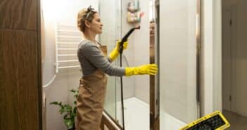 wet cleaning the bathroom with a steam cleaner