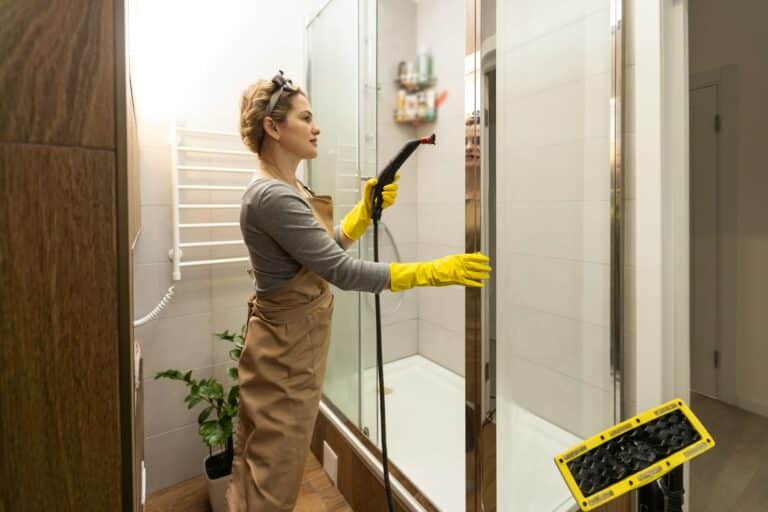 wet cleaning the bathroom with a steam cleaner