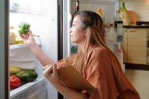 Woman checking fridge