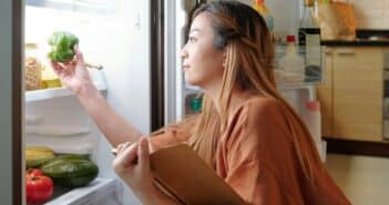 Woman checking fridge