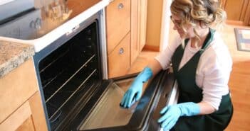 Woman cleaning oven