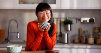 Woman drinking morning coffee in the kitchen