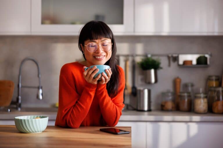 Woman drinking morning coffee in the kitchen