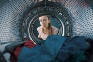 Woman loading the washing machine