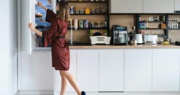 Woman looking into the fridge at home