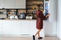 Woman looking into the fridge at home