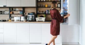 Woman looking into the fridge at home