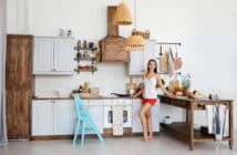 Woman standing by the stove in the kitchen