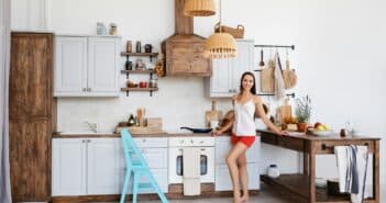 Woman standing by the stove in the kitchen