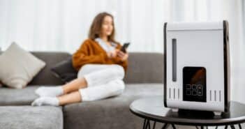 Woman with air humidifier at home