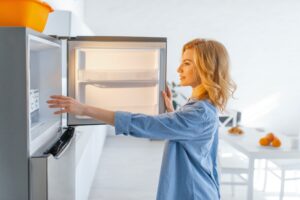 Young woman opened the fridge on the kitchen